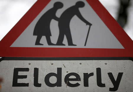 FILE PHOTO: A road sign warning drivers of elderly people crossing the road is seen in Hale, northern England February 19, 2015. REUTERS/Phil Noble/File Photo