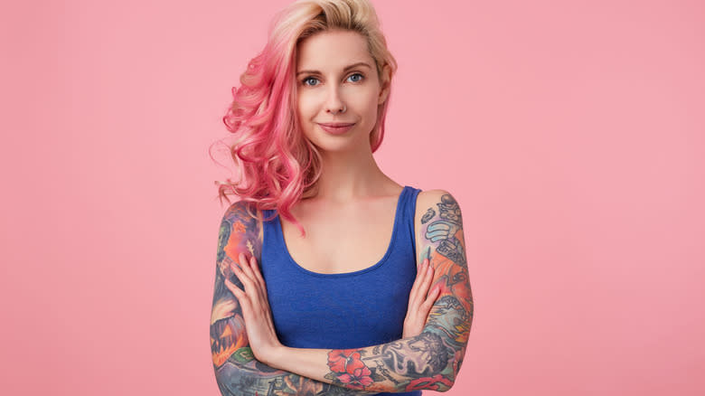 woman with pink hair and sleeve tattoos