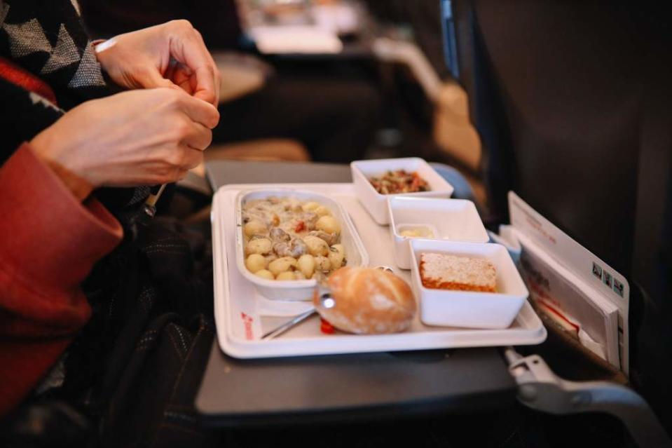 Wearing noise-canceling headphones might actually help your airplane food taste better. Getty Images