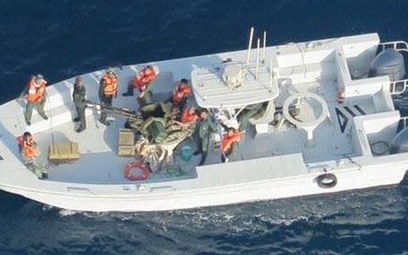 Imagery taken from a US Navy helicopter of what the US say is the Islamic Revolutionary Guard Corps Navy after removing an unexploded limpet mine from a tanker - Credit: US DEPARTMENT OF DEFENSE