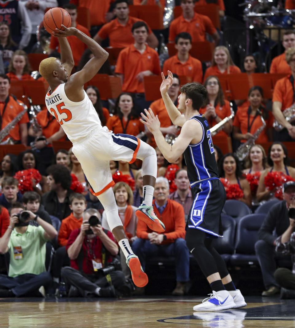 Virginia forward Mamadi Diakite (25) shoots over Duke forward Matthew Hurt (21) during an NCAA college basketball game Saturday, Feb. 29, 2020, in Charlottesville, Va. (AP Photo/Andrew Shurtleff)