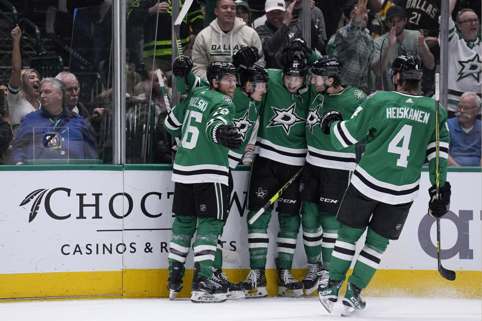 Dallas Stars' Joe Pavelski (16), Roope Hintz, second from left, Jason Robertson (21), Colin Miller (6) and Miro Heiskanen (4) celebrate after Hintz scored in the first period of an NHL hockey game against the Pittsburgh Penguins, Thursday, March 23, 2023, in Dallas. (AP Photo/Tony Gutierrez)