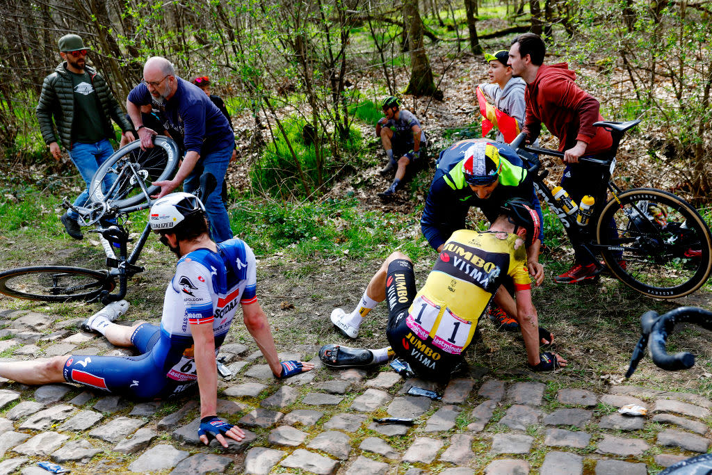  Kasper Asgreen and Dylan van Baarle sit on the Arenberg cobbles after crashing on the famous Paris-Roubaix sector 
