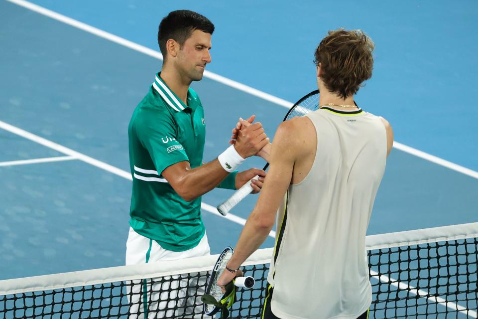 Novak Djokovic (pictured left) shakes hands with Alexander Zverev after their men's singles quarter-final match on day nine of the Australian Open.