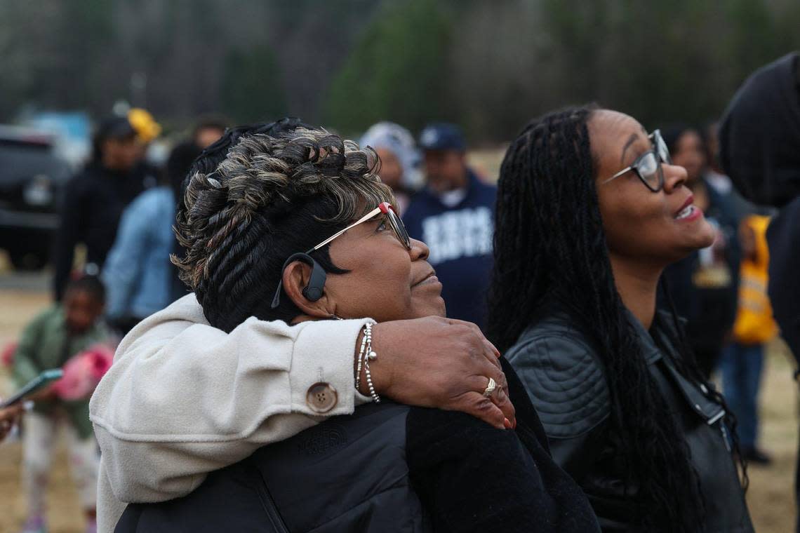 Salamondra Robinson, mother of Shanquella Robinson, is comforted as she watches balloons drift into the sky at Beatties Ford Memorial Garden on Sunday, January 8, 2023.