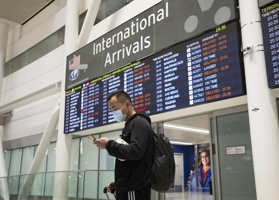 A man wears a masks following the outbreak of a new virus as people arrive from the International terminal at Toronto Pearson International Airport in Toronto on Saturday, Jan. 25, 2020. A Toronto hospital said Saturday it has a confirmed case of the deadly virus from China, Canada's first. Sunnybrook Health Sciences Centre said it is "caring for a patient who has a confirmed case of the novel coronavirus that originated in Wuhan, China." (Nathan Denette/The Canadian Press via AP)