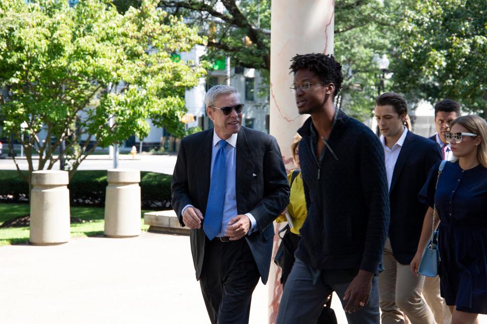 Former Palm Beach developer Robert V. Matthews, left, arrives July 31, 2023, with supporters at the federal courthouse in Bridgeport, Connecticut, where he was scheduled to be sentenced after pleading guilty to three felony counts in a case related, in part, to misuse of investors' funds in the Palm House hotel-renovation project in Palm Beach.