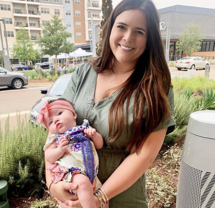 Tyler-Marie holding smiling as she holds her baby