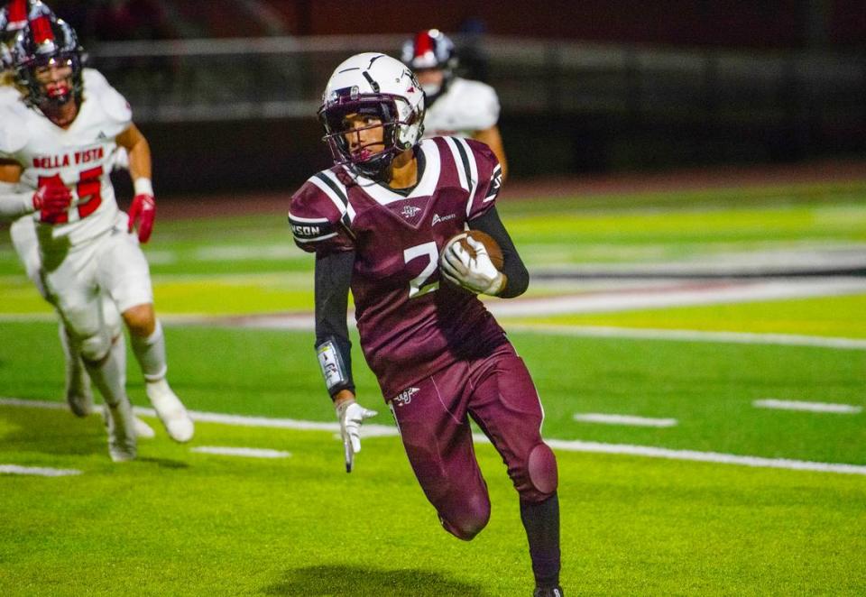 Hiram Johnson Warriors wide receiver James Hunter picks up some yards against the Bella Vista Broncos on Friday, Aug. 25, 2023, in Sacramento.