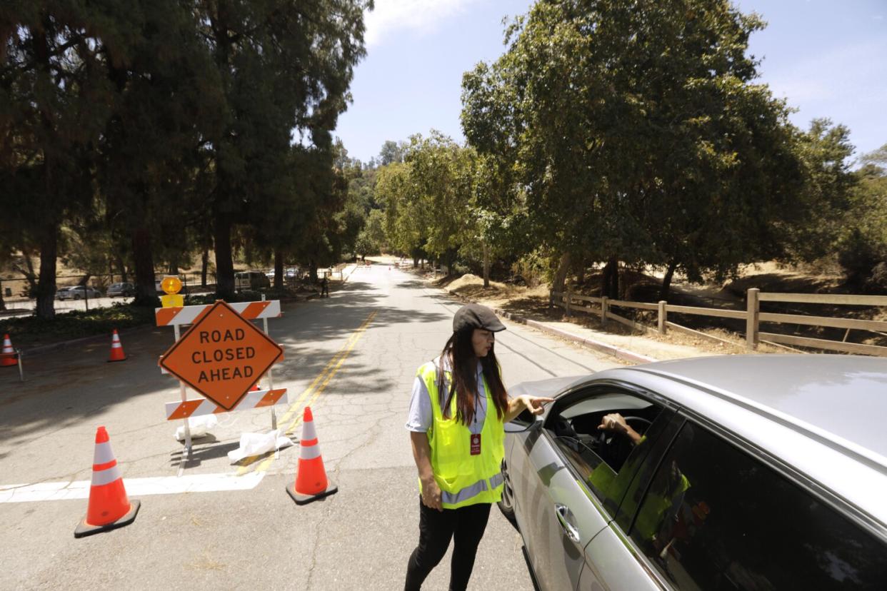 An L.A. City worker talks to a driver at Griffith Park