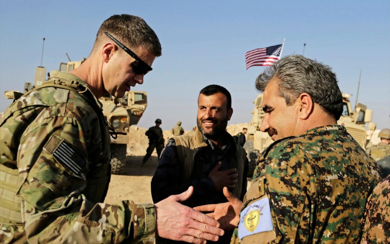 U.S. Army Maj. Gen. Jamie Jarrord, left, thanks Manbij Military Council commander Muhammed Abu Adeel during a visit to a small outpost near the town of Manbij - AP