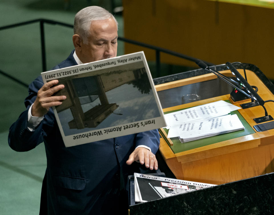 Israeli Prime Minister Benjamin Netanyahu prepares to display a photograph as he addresses the 73rd session of the United Nations General Assembly, at U.N. headquarters, Thursday, Sept. 27, 2018. (AP Photo/Craig Ruttle)