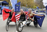 From left, women's wheelchair division second place finisher Manuela Schar, of Switzerland, winner Susannah Scaroni, and third place finisher Madison de Rozario, of Australia, pose at the finish line of the New York City Marathon, Sunday, Nov. 6, 2022, in New York. (AP Photo/Jason DeCrow)