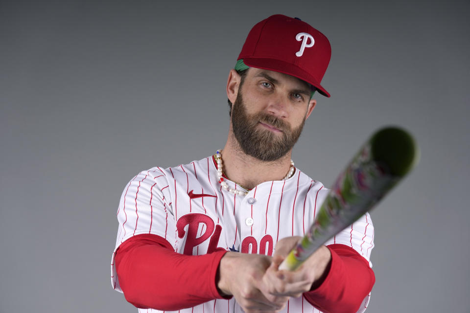 FILE - Philadelphia Phillies baseball baseball player Bryce Harper poses Thursday, Feb. 22, 2024, in Clearwater, Fla. There is a bridge that runs from Tommy John and Dr. Frank Jobe in 1974, all the way to Shohei Ohtani, Justin Verlander and Bryce Harper. A thread that connects an increasing number of baseball's biggest stars. Mostly on the mound, but at the plate, too. (AP Photo/Charlie Neibergall, File)