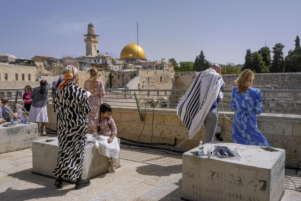 Jews participate in the Cohanim Priestly caste blessing during the holiday of Passover, overlooking the Western Wall, the holiest site where Jews can pray, with the golden Dome of the Rock in the background, in Jerusalem's Old City, Thursday, April 25, 2024. The Cohanim, believed to be descendants of priests who served God in the Jewish Temple before it was destroyed, perform a blessing ceremony of the Jewish people three times a year during the festivals of Passover, Shavuot and Sukkot. (AP Photo/Ohad Zwigenberg)