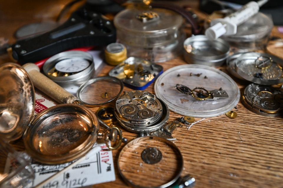 Old timepieces in for repair, seen Wednesday, Jan. 31, 2024, at jeweler Stewart Powell's repair desk at Linn & Owen Jewelers in Lansing.