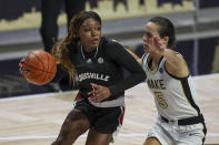 Louisville guard Dana Evans, left, drives around Wake Forest guard Gina Conti (5) in the first quarter of an NCAA women's college basketball game in Winston-Salem, N.C., Sunday, Jan. 24, 2021. (AP Photo/Nell Redmond)