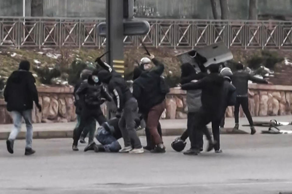 A frame grab from AFPTV video shot on January 5, 2022, shows protesters clashing with Kazakstan's security forces during a demonstration in Almaty, amid unprecedented unrest in the Central Asian nation. Protesters took police officers' gear and tear gas during clashes in Almaty that caused a number of deaths. / Credit: ALEXANDER PLATONOV/AFPTV/AFP/Getty