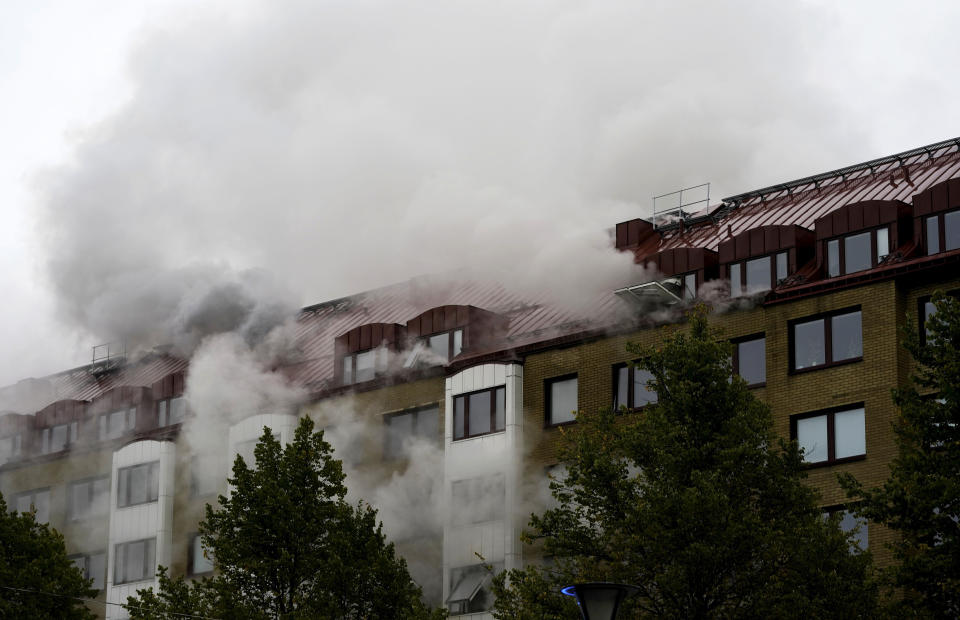 Smoke billows from an apartment building after an explosion in Annedal, central Gothenburg, Sweden, Tuesday Sept. 28, 2021. The explosion took place in the early hours of the morning, and rescue services are still working to extinguish fires that spread to several apartments. (Bjorn Larsson Rosvall/TT via AP)