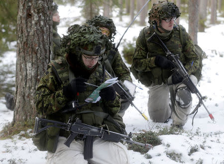 An Estonian army conscript soldiers attend a tactical training in the military training field near Tapa, Estonia February 16, 2017. REUTERS/Ints Kalnins