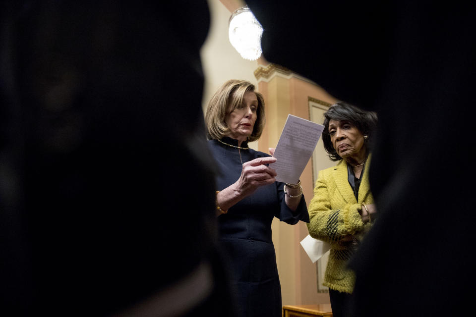 House Speaker Nancy Pelosi of Calif., left, accompanied by House Financial Services Committee Chairwoman Maxine Waters, D-Calif., right, and other House leadership, reviews her speech notes in a private room just off the House floor after the House votes to impeach President Donald Trump, Wednesday, Dec. 18, 2019, on Capitol Hill in Washington. (AP Photo/Andrew Harnik)