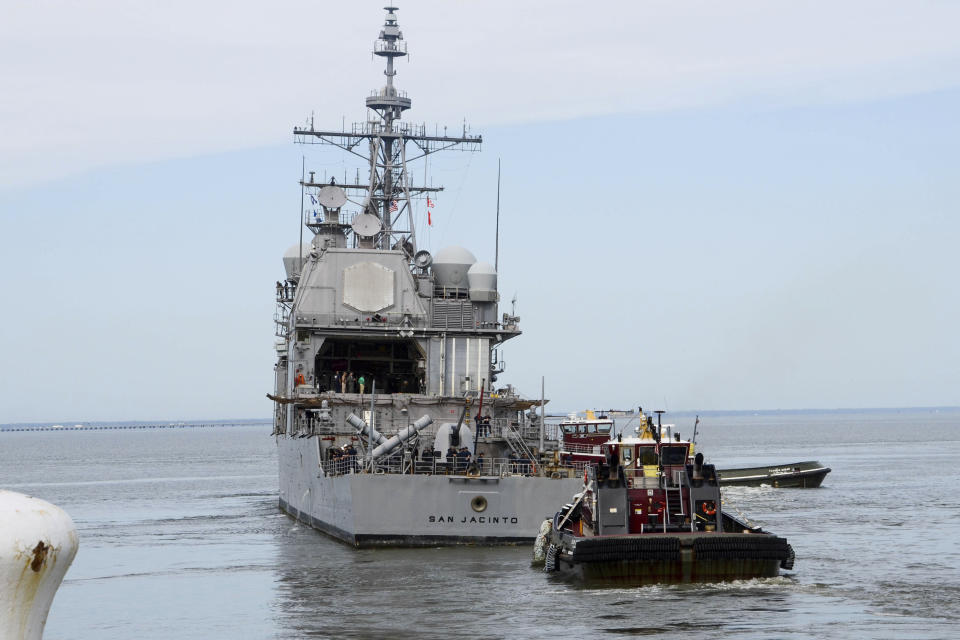 This image provided by the US Navy shows the USS San Jacinto (CG-56) as it heads out of the it's berth at Naval Station Norfolk ahead of Hurricane Dorian in Norfolk, Va., Wednesday Sept. 4, 2019. The U.S. Navy has ordered ships based on Virginia's coast to head out to sea to avoid Hurricane Dorian. (Alton Dunham/US Navy via AP)