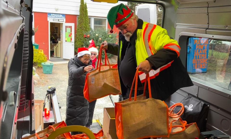 Volunteers load a Bay Rides van full of bags from the food bank for residents around St. Margaret's Bay during Christmas 2023. The rural transit group provides free delivery for food bank orders to those without reliable transportation.