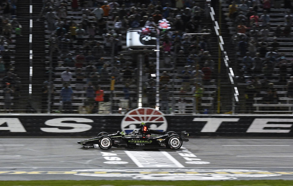 Josef Newgarden takes the checkered flag to win the IndyCar auto race at Texas Motor Speedway, Saturday, June 8, 2019, in Fort Worth, Texas. (AP Photo/Larry Papke)