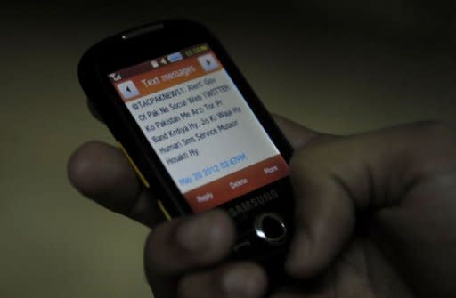 A Pakistani resident reads a message on a cellular telephone refering to the blocked social networking website Twitter in Quetta. The website, which is widely used in Pakistan, was blocked by the telecoms authority on the orders of the IT ministry, with authorities accusing Twitter of refusing to remove posts about the Facebook contest