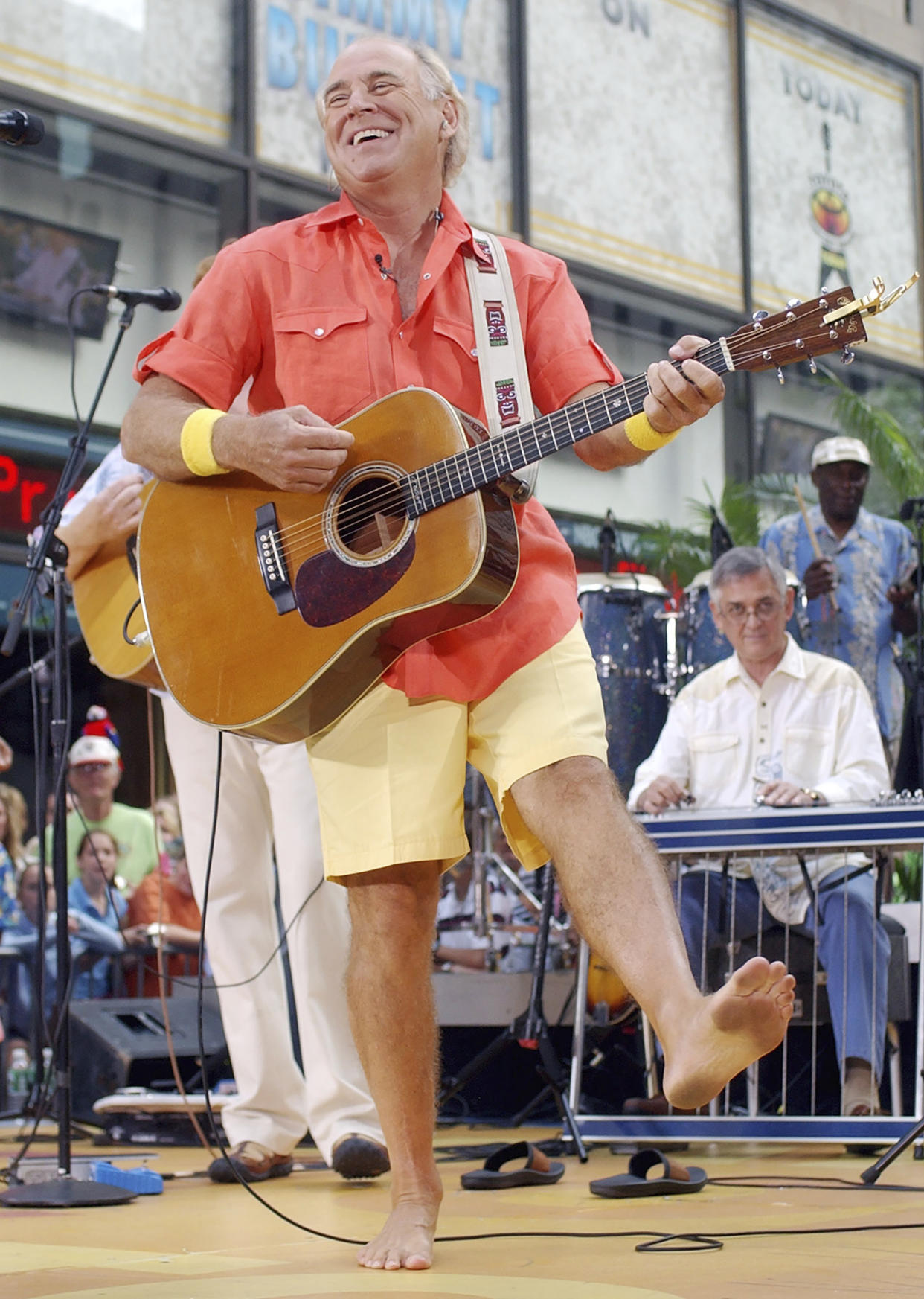 FILE - Singer Jimmy Buffet performs barefooted with his band The Coral Reefers on the NBC "Today" television show summer concert series in New York's Rockefeller Plaza, on June 25, 2004. “Margaritaville” singer-songwriter Jimmy Buffett has died at age 76. A statement on Buffett's official website and social media pages says the singer died Friday, Sept. 1, 2023 “surrounded by his family, friends, music and dogs”. (AP Photo/Richard Drew, File)
