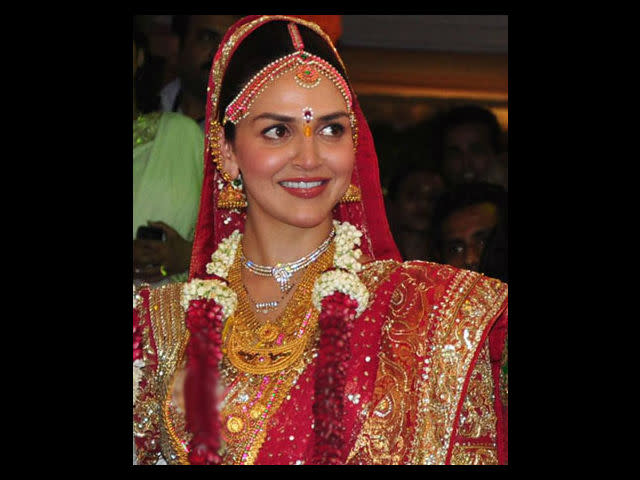 Her marriage was a traditional South Indian wedding in a temple. She wore a red lehenga made of three kanjivaram saris. Traditional gold jewellery completed her wedding look. Bharat wore a white sherwani with zardozi work. Hema Malini’s close friend designer Neeta Lulla designed the beautiful outfits.