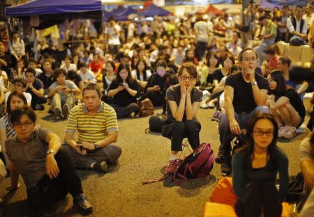 A pro-democracy demonstrator reacts during a speech after the government cancelled talks scheduled for Friday as protesters block areas around the government headquarters office in Hong Kong October 9, 2014. REUTERS/Carlos Barria