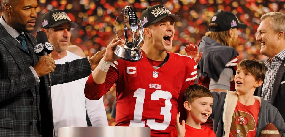 San Francisco 49ers quarterback Brock Purdy holds the George Halas Trophy while after winning the NFC Championship Game against the visiting Detroit Lions, Jan. 28, 2024.