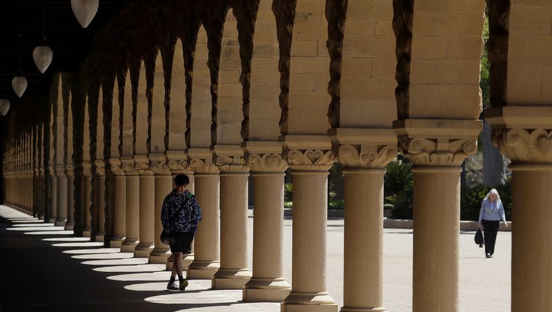 In this April 9, 2019, file photo, pedestrians walk on the campus at Stanford University in Stanford, Calif.