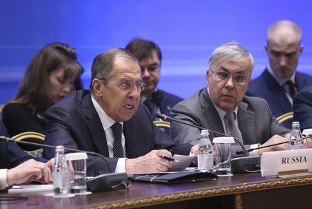 Russian Foreign Minister Sergei Lavrov (L) speaks during the international meeting on Syria in Astana, Kazakhstan March 16, 2018. REUTERS/Mukhtar Kholdorbekov