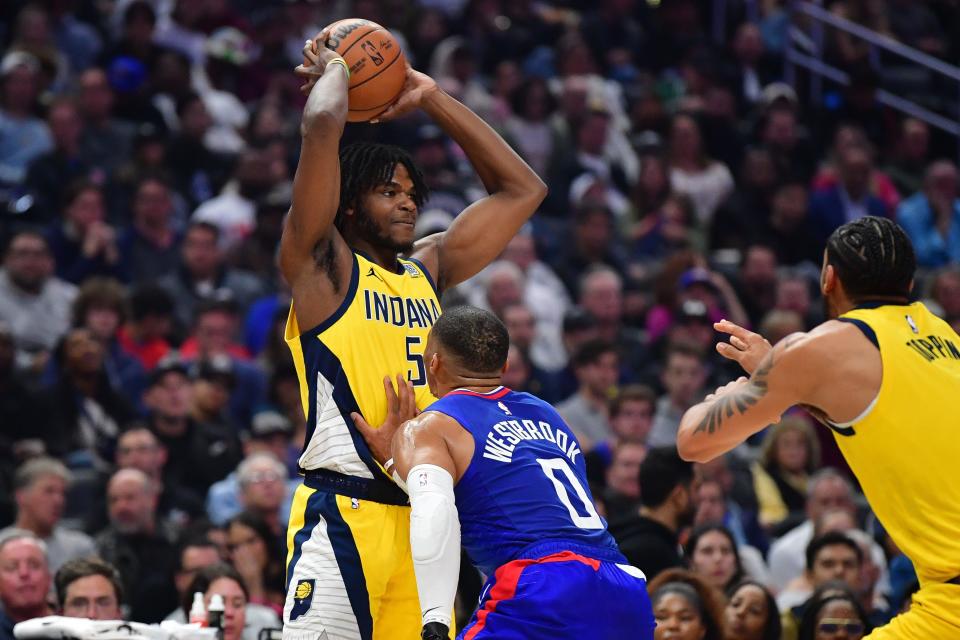 Mar 25, 2024; Los Angeles, California, USA; Indiana Pacers forward Jarace Walker (5) controls the ball against Los Angeles Clippers guard Russell Westbrook (0) during the first half at Crypto.com Arena. Mandatory Credit: Gary A. Vasquez-USA TODAY Sports