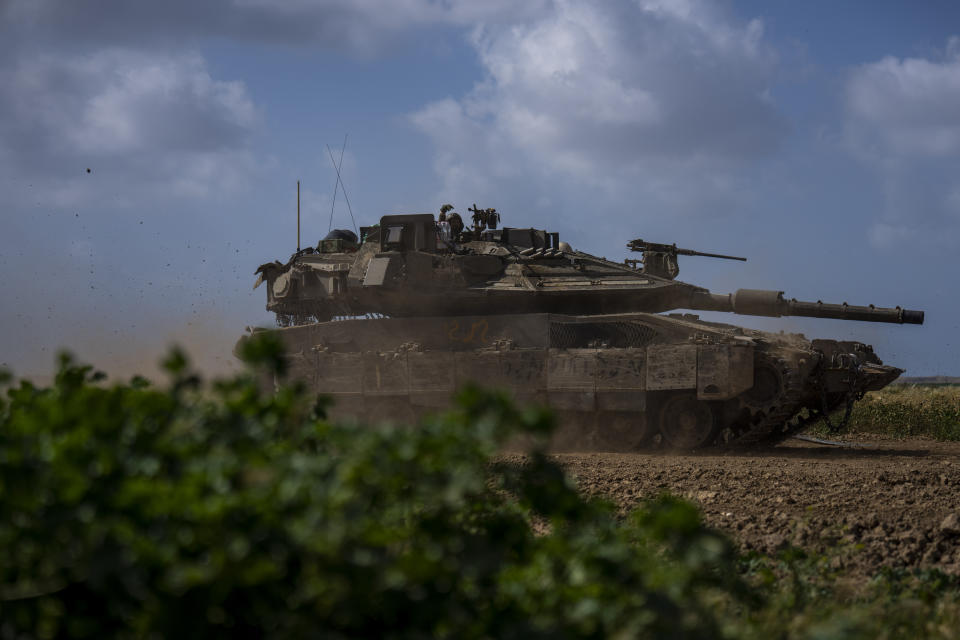 FILE - Israeli soldiers drive a tank on the border with Gaza Strip, in southern Israel, March 19, 2024. Israel and Hamas appear to be seriously negotiating an end to the war in Gaza and the return of Israeli hostages. A leaked truce proposal hints at concessions by both sides following months of stalemated talks. (AP Photo/Ariel Schalit, File)