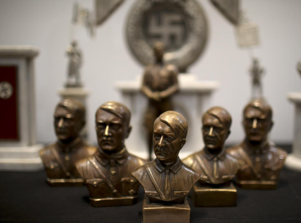 Busts of German Nazi leader Adolf Hitler discovered by police in 2017 are displayed during a press conference in Buenos Aires, Argentina, Wednesday, Oct. 2, 2019. Argentine authorities found the cache of Nazi artifacts in a secret room behind a bookcase and said that they had uncovered the collection in the course of a wider investigation into artwork of suspicious origin found at a gallery in Buenos Aires. (AP Photo/Natacha Pisarenko)