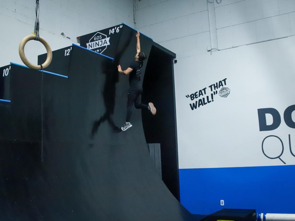 Drew Nester runs up a 14'6" wall at 605 Ninja on Tuesday, June 7. Nester, an employee at 605 Ninja, is competing on the popular television show "American Ninja Warrior."