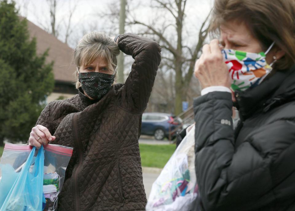 Mary Thompson, left, and her sister Patty Takavitz delivered dozens of homemade masks for staff serving youth at the St. Vincent Family Center, a residential treatment center for children, in  Columbus on Wednesday.