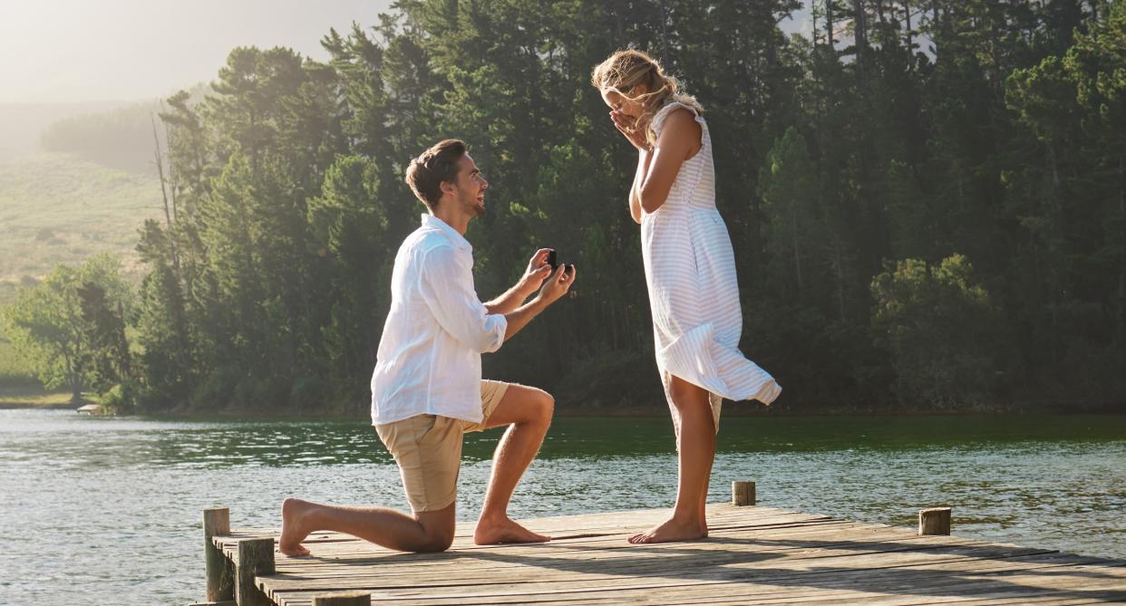 A man gets on one knee to propose to his girlfriend. (Getty Images)