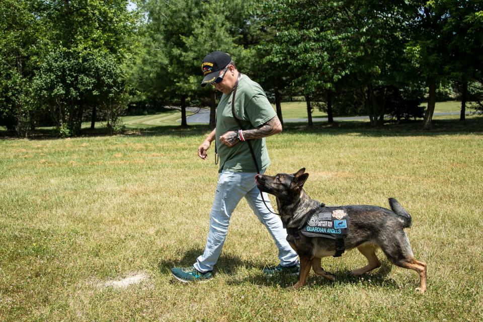Navy veteran Sheldon Ewers of Jackson with his Guardian Angel service dog Patsy in Ann Arbor on June 30, 2022.