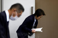 President of the Tokyo 2020 Olympics Organizing Committee Seiko Hashimoto, right, bows as she leaves after her speech at a press briefing on the operation and media coverage of Tokyo 2020 Olympic Torch Relay in Tokyo Thursday, Feb. 25, 2021. (Behrouz Mehri/Pool Photo via AP)