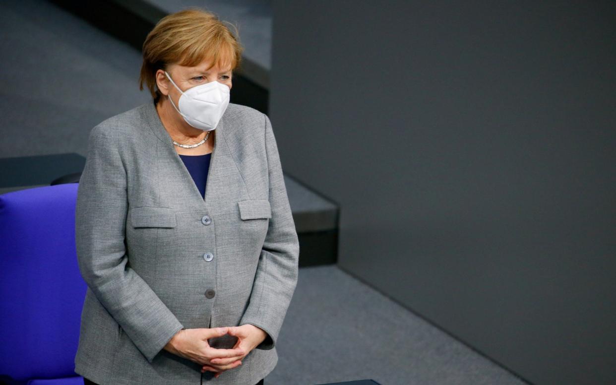 FILE PHOTO: German Chancellor Angela Merkel attends a session at the lower house of parliament Bundestag on the start of the coronavirus disease (COVID-19) vaccinations, in Berlin, Germany, January 13, 2021. REUTERS/Michele Tantussi/File Photo -  MICHELE TANTUSSI/REUTERS