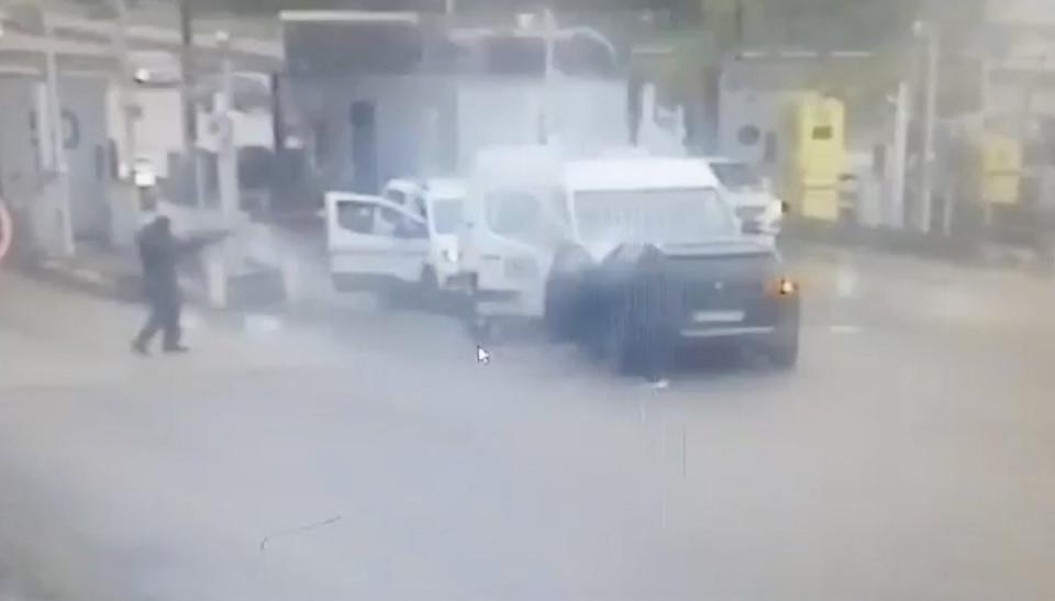 A screen grab from a CCTV video shows a person aiming as gunmen wearing balaclavas ambush a prison van (via REUTERS)