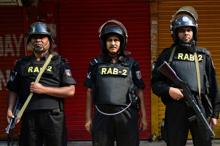 Bangladeshi Rapid Action Battalion (RAB) personnel stand guard during a nationwide strike in Dhaka on March 4, 2013. Schools and businesses were shut Monday across Bangladesh on the second day of a general strike called by Islamist protesters, as three more demonstrators died in the deadliest violence since independence