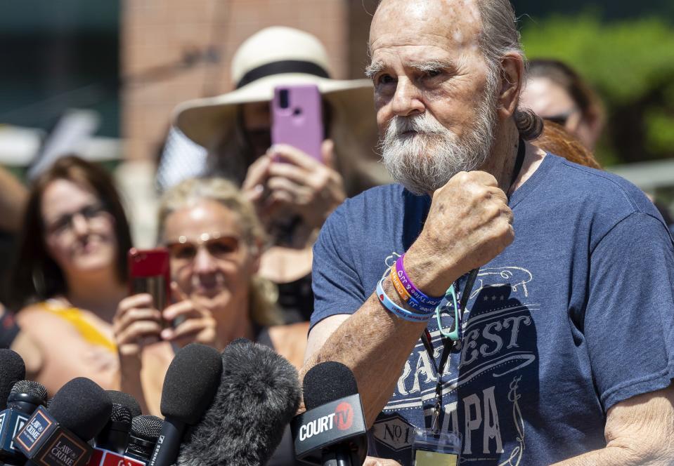Larry Woodcock holds up his fist showing wristbands in memory of his grandson Joshua “JJ” Vallow and his sibling Tylee Ryan while speaking to the media outside of the Ada County Courthouse in Boise, Idaho, on Friday, May 12, 2023. Idaho mother Lori Vallow Daybell was convicted Friday in the murders of her two youngest children and a romantic rival, a verdict that culminates a three-year investigation that included bizarre claims that her son and daughter were zombies and she was a goddess sent to usher in the Biblical apocalypse. | Sarah A. Miller, Idaho Statesman via Associated Press