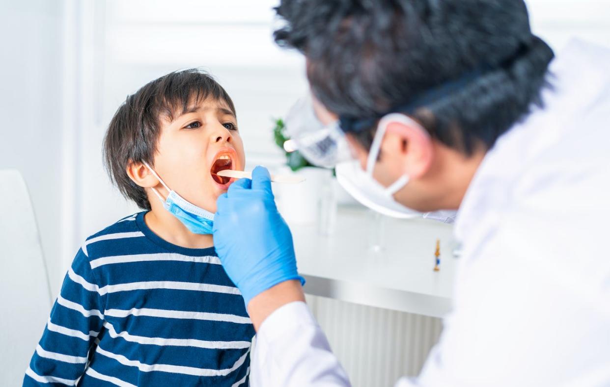Strep is most common in children between the ages of 5 and 15. <a href="https://www.gettyimages.com/detail/photo/male-pediatrician-examining-little-child-patients-royalty-free-image/1306247195?phrase=doctor+checking+for+strep&adppopup=true" rel="nofollow noopener" target="_blank" data-ylk="slk:aquaArts studio/E+ via Getty Images;elm:context_link;itc:0;sec:content-canvas" class="link ">aquaArts studio/E+ via Getty Images</a>