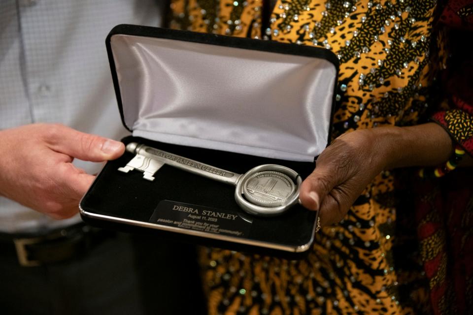 Mayor James Mueller and Debra Stanley hold the Key to the City of South Bend at the Charles Martin Youth Center in South Bend on Friday, Aug. 11, 2023, after he had presented it to her.