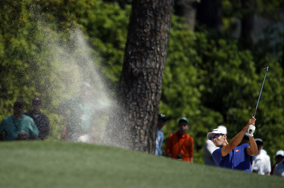 Adam Scott, of Australia, hits out of a bunker on the first fairway during the third round of the Masters golf tournament Saturday, April 12, 2014, in Augusta, Ga. (AP Photo/Matt Slocum)